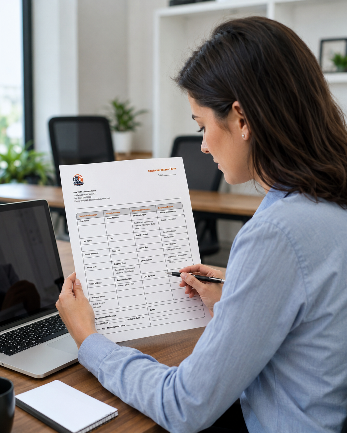 Office manager reviewing a printed HVAC Customer Intake Form template